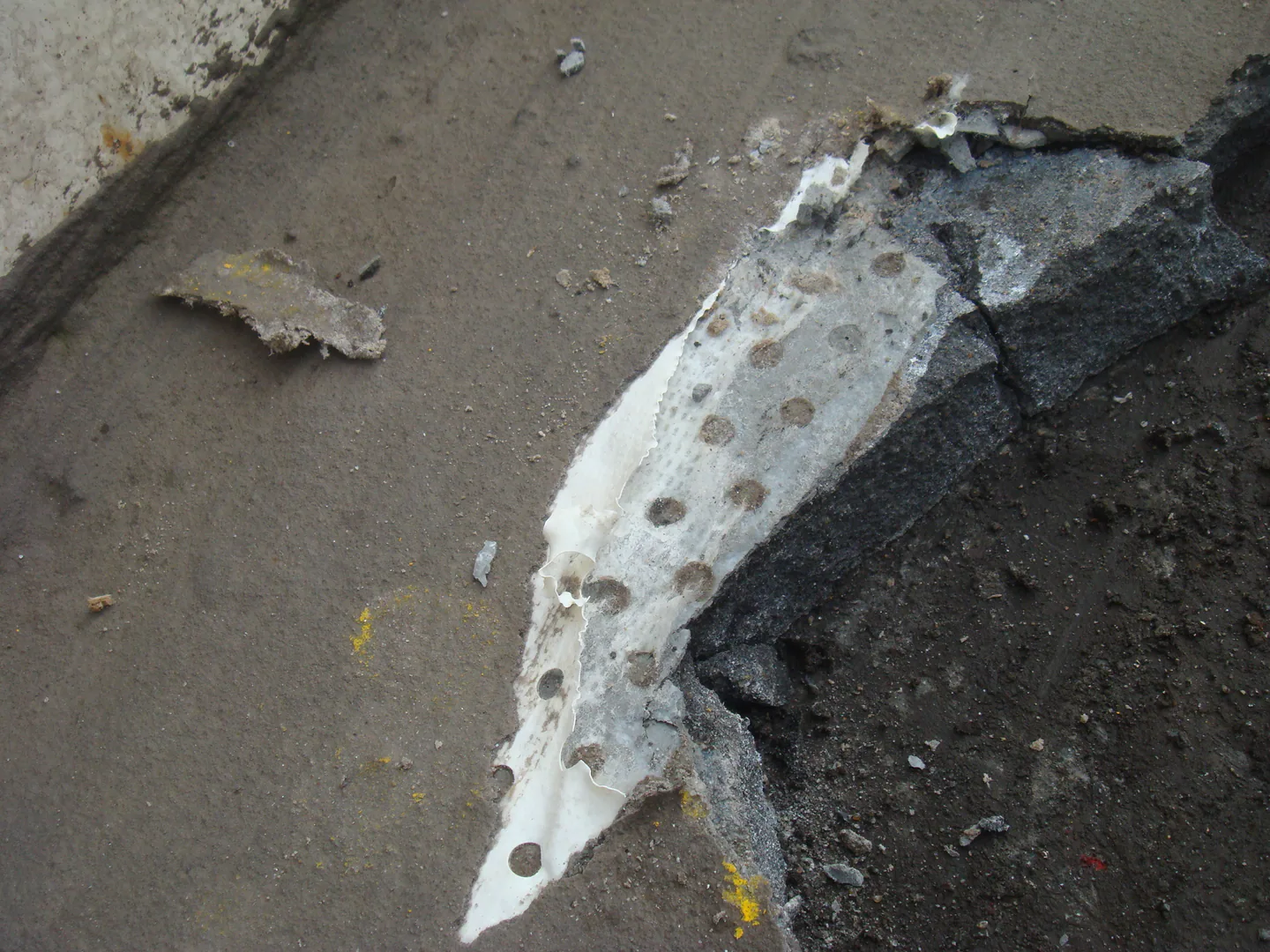 Exposed transition at the storage tank shell-to-foundation interface before protection.