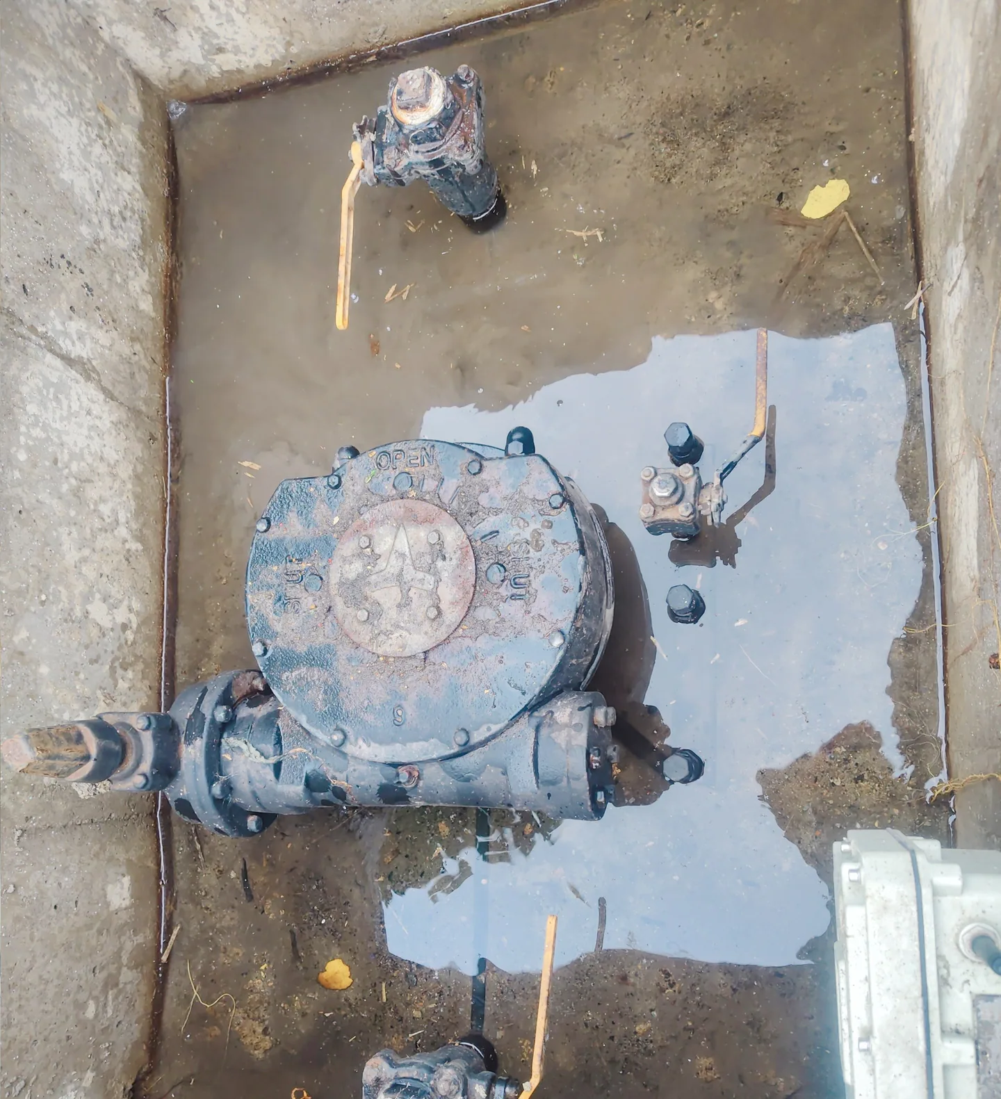 Valve and flange assembly surrounded by standing water in a Nanjing underground chamber before protection.